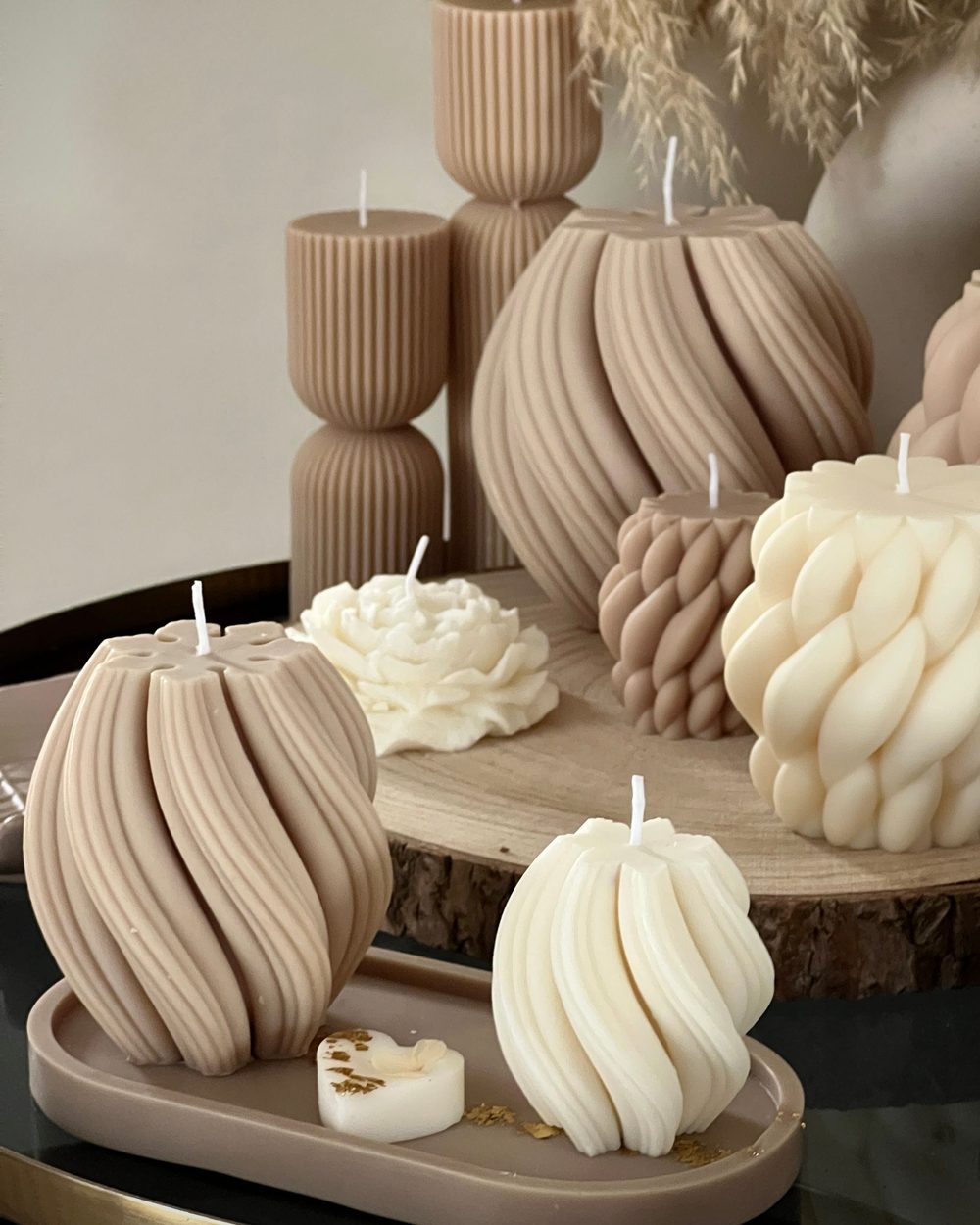 Sculpted candles in cream and taupe, twisted and ribbed shapes