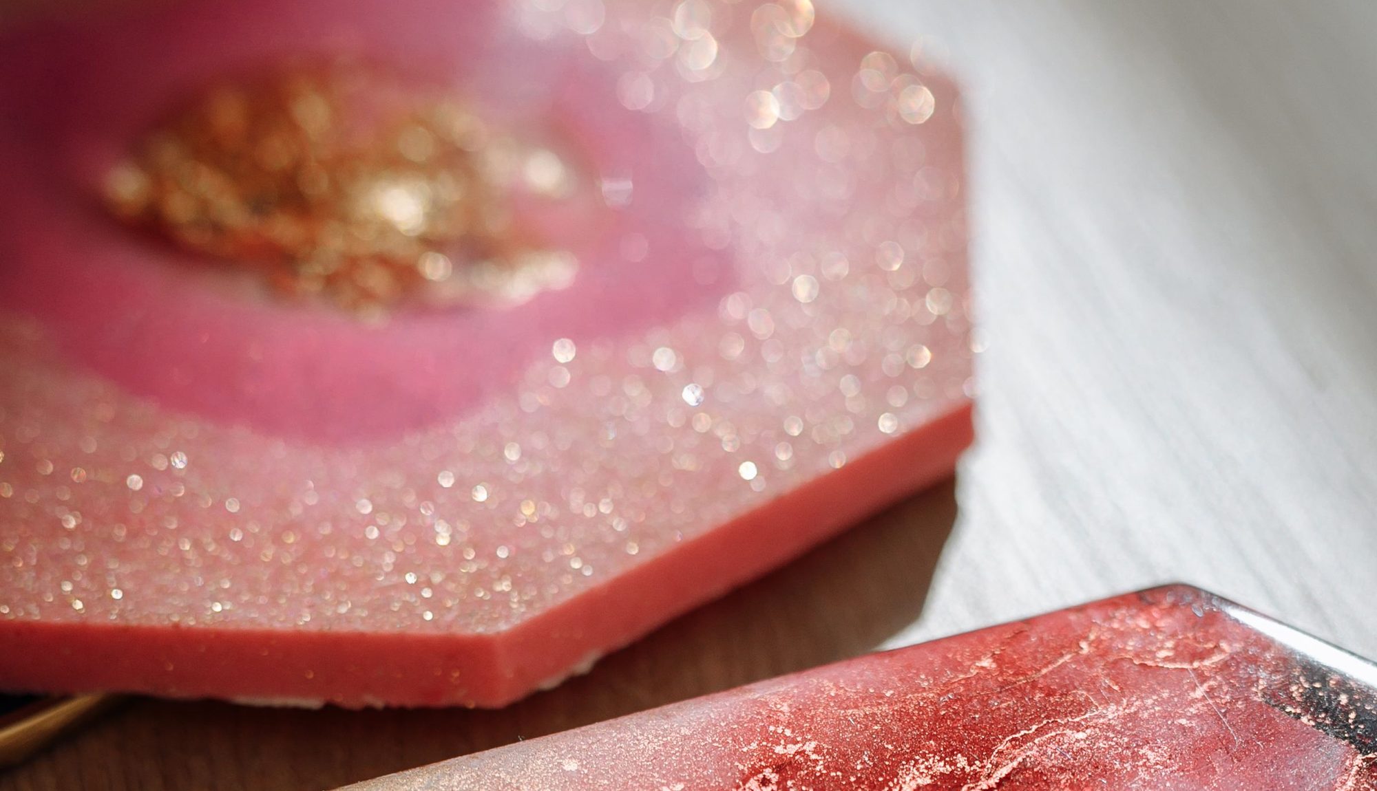 Close-up of a pink resin piece with gold veining